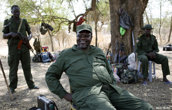 South Sudan's rebel leader Riek Machar sits near his men in a rebel-controlled territory in Jonglei State January 31, 2014. A regional African group mediating to end the conflict in South Sudan aims to deploy the first monitors of a shaky ceasefire at the weekend, senior officials said on Friday. The government of President Salva Kiir and rebels loyal to his sacked deputy Riek Machar agreed a ceasefire deal on January 23, but both sides have accused each other of violations. REUTERS/Goran Tomasevic (SOUTH SUDAN - Tags: CIVIL UNREST POLITICS TPX IMAGES OF THE DAY) - RTX182IC