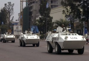 U.N. troops in armored vehicles drive through the streets of Kinshasa, Congo, on Aug. 21, 2006. (John Bompeng/AP)